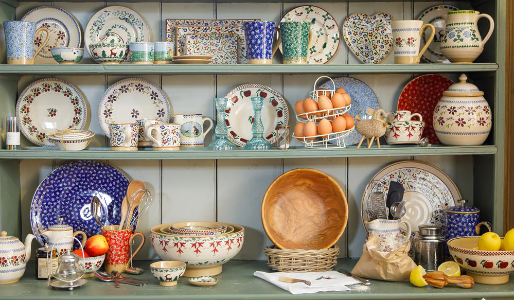 Green dresser full of Nicholas Mosse Pottery