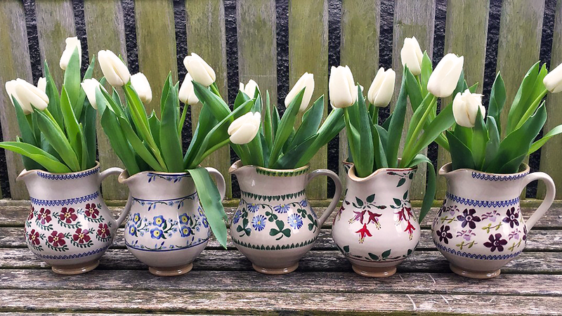 Nicholas Mosse  spring flowers tulips in medium jugs old rose, forget me not, clover, fuchsia and clematis